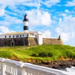 Salvador da Bahia, Brazil - May 29, 2016: View of Farol da Barra Lighthouse at Barra beach in Salvador da Bahia, Brazil. Dating from the year 1698, it is said to be the oldest lighthouse in South America.