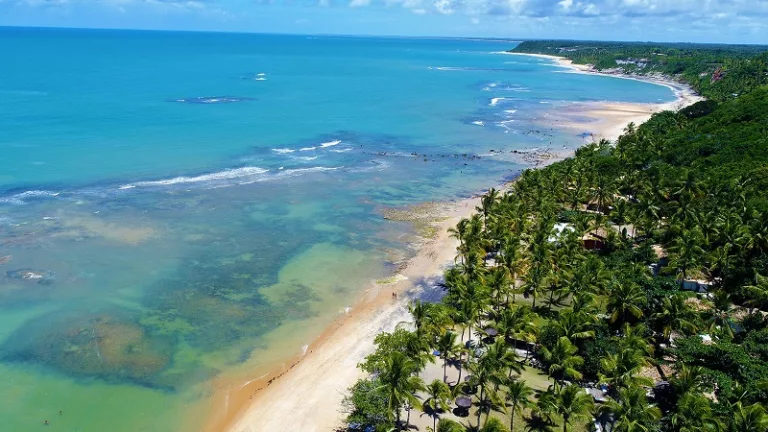 Aerial view of a crystal water of a paradisiac beach. Fantastic landscape. Great beach scene. Trancoso, Bahia, Brazil. Travel destination. Vacation travel.